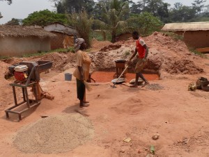 People sweeping the floor for gold ore